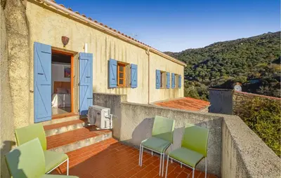 a balcony of a house with green chairs at Lovely Home In Montegrosso With Wifi in Montegrosso