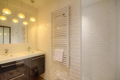 a white bathroom with a sink and a mirror at Le Campu Latinu in Lama
