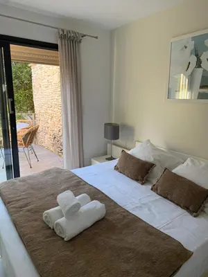 a bedroom with a large white bed with towels on it at Casa Martini in Bonifacio