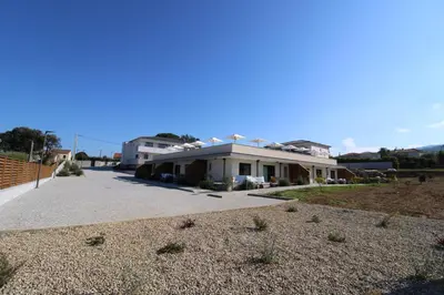 a driveway entrance to a house with a garage at hôtel résidence a torra in Vescovato