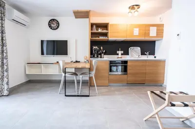 a kitchen and dining room with a table and chairs at hôtel résidence a torra in Vescovato