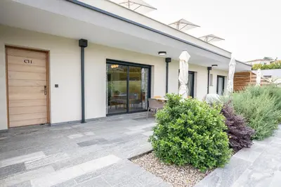 a house with a patio and a door at hôtel résidence a torra in Vescovato