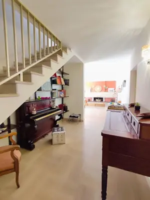 a living room with a staircase and a piano at Villa A CASA DI FICU à 14kms d'Ajaccio et des plages avec Piscine Jacuzzi Pétanque Sans vis à vis in Peri