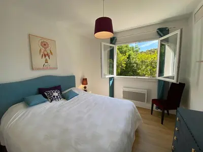 a bedroom with a large bed and a window at Villa A CASA DI FICU à 14kms d'Ajaccio et des plages avec Piscine Jacuzzi Pétanque Sans vis à vis in Peri
