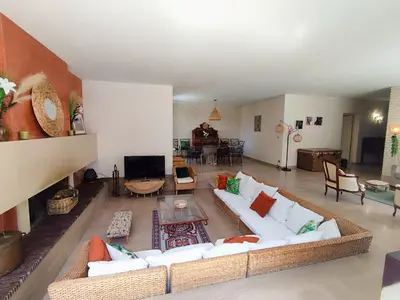 a living room with white couches and a television at Villa A CASA DI FICU à 14kms d'Ajaccio et des plages avec Piscine Jacuzzi Pétanque Sans vis à vis in Peri