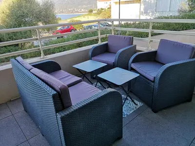 a group of chairs and tables on a balcony at T3 vue mer à Propriano in Propriano