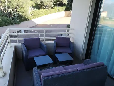 two purple chairs and a table on a balcony at T3 vue mer à Propriano in Propriano