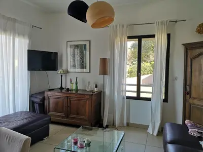 a living room with a couch and a window at T3 vue mer à Propriano in Propriano