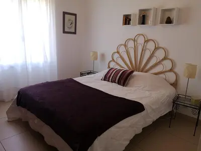 a bedroom with a large bed with a large headboard at T3 vue mer à Propriano in Propriano