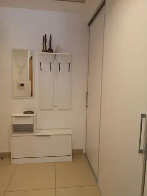 a white bathroom with a glass shower door at T3 vue mer à Propriano in Propriano