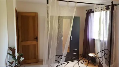a room with a door and a window with curtains at Appartement Caroline in Sotta