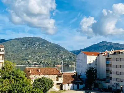 a view of a city with mountains in the background at Joli deux pièces, centre ville et proche plage in Propriano