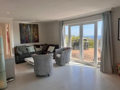 a living room with a couch and chairs and sliding glass doors at VILLA GIOIA -Vue mer- proche plage de Favone in Conca