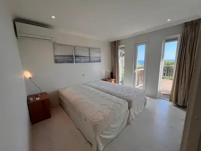 a bedroom with a bed and a large window at VILLA GIOIA -Vue mer- proche plage de Favone in Conca