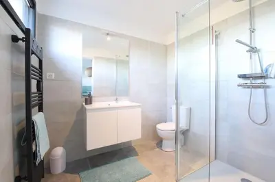a bathroom with a toilet and a glass shower at Villa-soleil-levant vue mer panoramique in Sari Solenzara