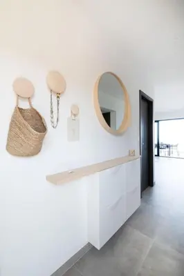 a white bathroom with a mirror and a counter at Villa-soleil-levant vue mer panoramique in Sari Solenzara