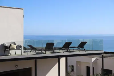 a group of chairs sitting on top of a building at Villa-soleil-levant vue mer panoramique in Sari Solenzara