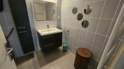 a small bathroom with a sink and a mirror at DOLCE VITA in Kamiesch