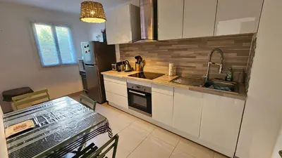 a kitchen with white cabinets and a sink and a refrigerator at DOLCE VITA in Kamiesch