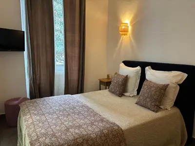 a bedroom with a bed and a large window at Hotel U Campanile in Vivario