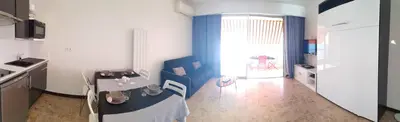 a kitchen with a table and a dining room at Sudio bord de mer Ajaccio in Ajaccio