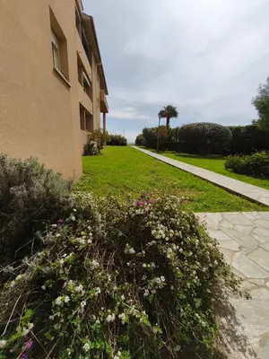a sidewalk next to a building with flowers at Appartement T2 Bord de Mer - Maria Beach in Santa-Lucia-di-Moriani