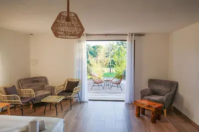 a room with chairs and a bed and a patio at Résidence de la Plage in Porto-Vecchio