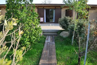 a walkway leading to the front of a house at Résidence de la Plage in Porto-Vecchio