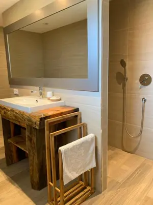 a bathroom with a sink and a large mirror at Résidence de la Plage in Porto-Vecchio