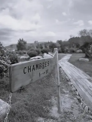 a sign that reads chaminetts on a dirt road at Résidence de la Plage in Porto-Vecchio