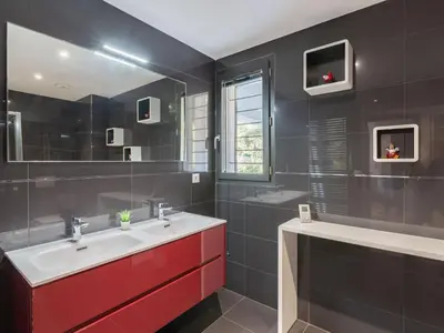 a bathroom with a red sink and a mirror at Apartment Domaine d'Arca-3 by Interhome in Porto-Vecchio