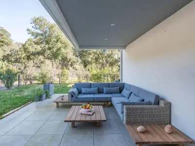 a living room with a blue couch and a table at Apartment Domaine d'Arca-3 by Interhome in Porto-Vecchio