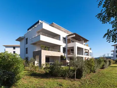 a white building with bushes in front of it at Apartment Domaine d'Arca-3 by Interhome in Porto-Vecchio