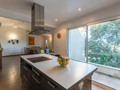 a kitchen with a bowl of fruit on a counter at Holiday Home Villa Boccajo by Interhome in Porto-Vecchio