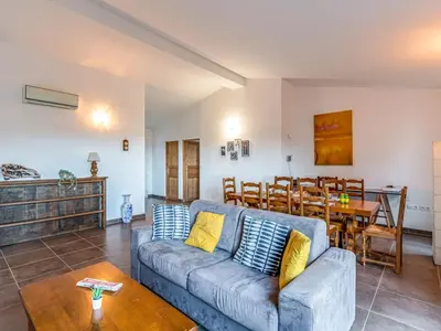 a living room with a couch and a table at Holiday Home Villa Boccajo by Interhome in Porto-Vecchio