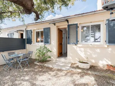 a house with a table and chairs in front of it at Holiday Home Signoria by Interhome in Sari Solenzara