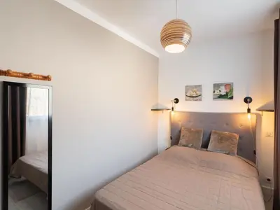 a bedroom with a bed and a large window at Holiday Home Signoria by Interhome in Sari Solenzara