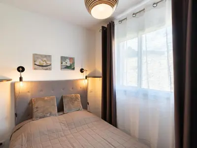 a bedroom with a bed and a mirror at Holiday Home Signoria by Interhome in Sari Solenzara