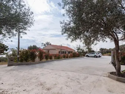 a parking lot with a car parked in front of a house at Apartment Cappone by Interhome in Sari Solenzara