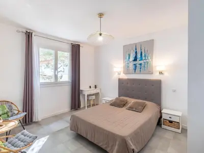 a bedroom with a bed and a tv on the wall at Holiday Home Polpu by Interhome in Sari Solenzara
