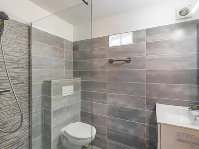 a bathroom with a shower and a toilet and a sink at Holiday Home Sepia by Interhome in Sari Solenzara
