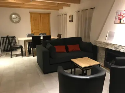 a living room with a couch and a table at Casa Natalina de caractère entièrement rénovée classée 4 étoiles in Feliceto