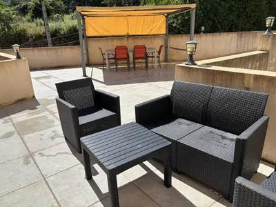two chairs and a table and chairs on a patio at Casa Natalina de caractère entièrement rénovée classée 4 étoiles in Feliceto