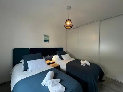 a room with two beds with towels on them at BEL'ORIZONTE Proche centre ville et plage, vue mer in Propriano