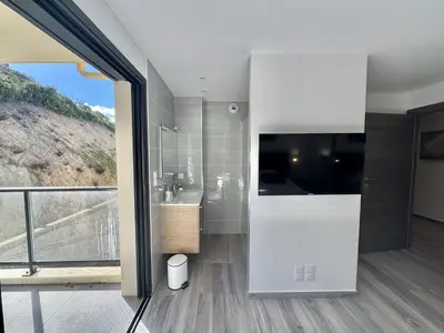 a bathroom with a sink and a large window at Fronte di Mare - Grand confort vue mer in Propriano