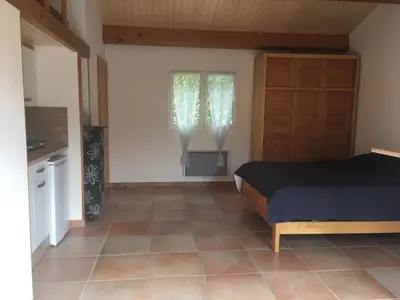a bedroom with a bed and a window at Charmant studio avec piscine . in Afa