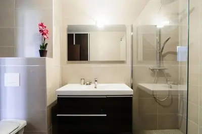 a bathroom with a sink and a toilet and a mirror at T2 PORTICCIO AGOSTA PLAGE 100M DE LA PLAGE in Porticcio