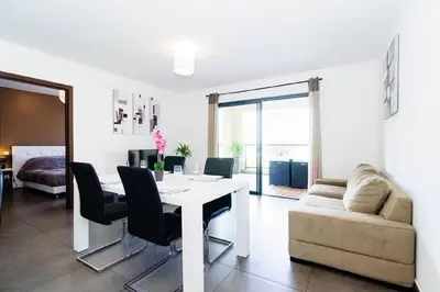 a living room with a white table and a couch at T2 PORTICCIO AGOSTA PLAGE 100M DE LA PLAGE in Porticcio