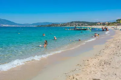 a group of people in the water at a beach at T2 PORTICCIO AGOSTA PLAGE 100M DE LA PLAGE in Porticcio