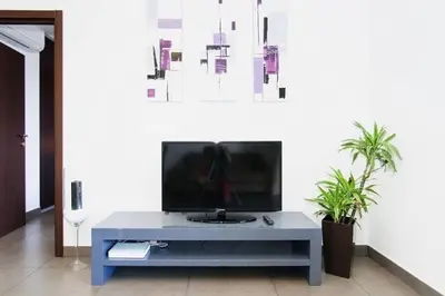 a living room with a tv on a table at T2 PORTICCIO AGOSTA PLAGE 100M DE LA PLAGE in Porticcio